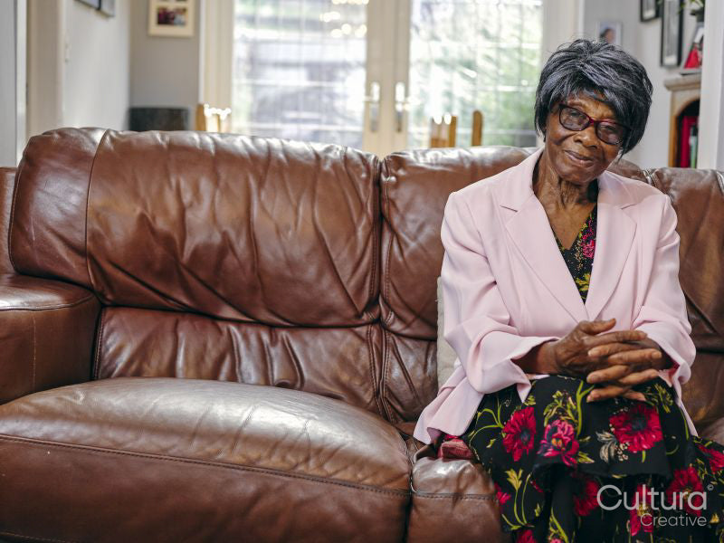 Smiling senior woman sitting on sofa