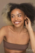 Studio portrait of smiling woman with two toned hair