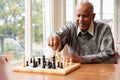 Senior man playing chess in nursing home