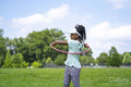 Girl using plastic hoop in park