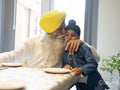 Grandfather kissing grandson on cheek