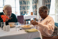 Senior people eating meal in nursing home
