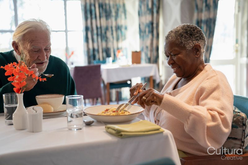Senior people eating meal in nursing home