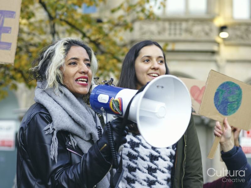 Activists holding peace signs protesting in street
