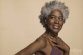 Studio portrait of smiling mature woman