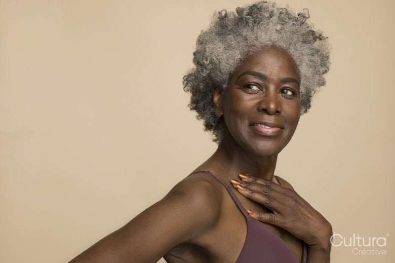 Studio portrait of smiling mature woman