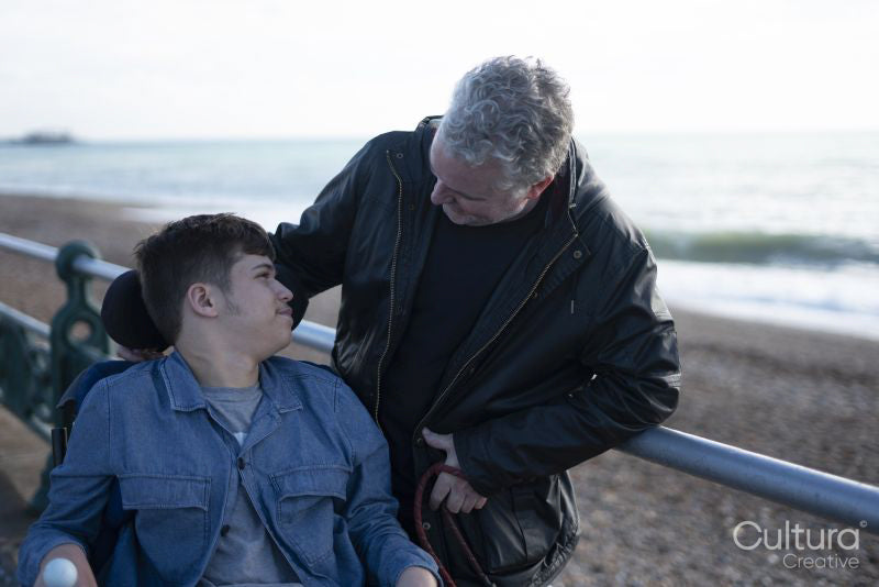 Portrait of father and son by the sea