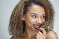 Studio portrait of smiling woman with curly hair