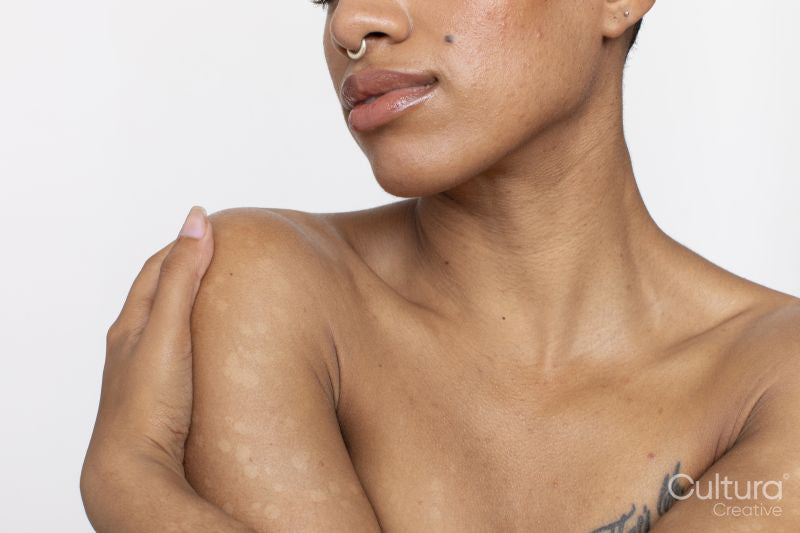 Close-up of shirtless woman with arms crossed