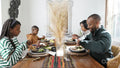 Family with children eating Kwanzaa meal