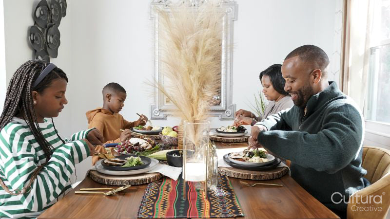 Family with children eating Kwanzaa meal
