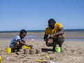 Father and son building sand castles on beach
