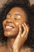 Studio shot of smiling woman with curly hair