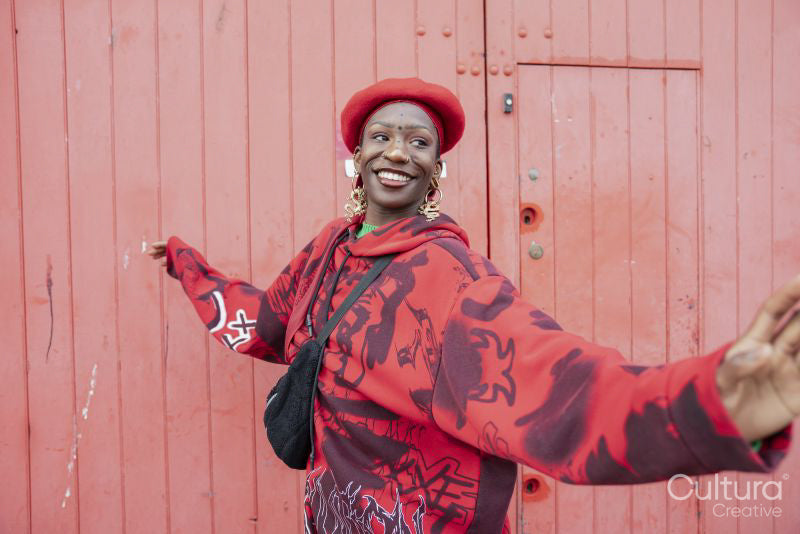 Smiling young woman in red dancing