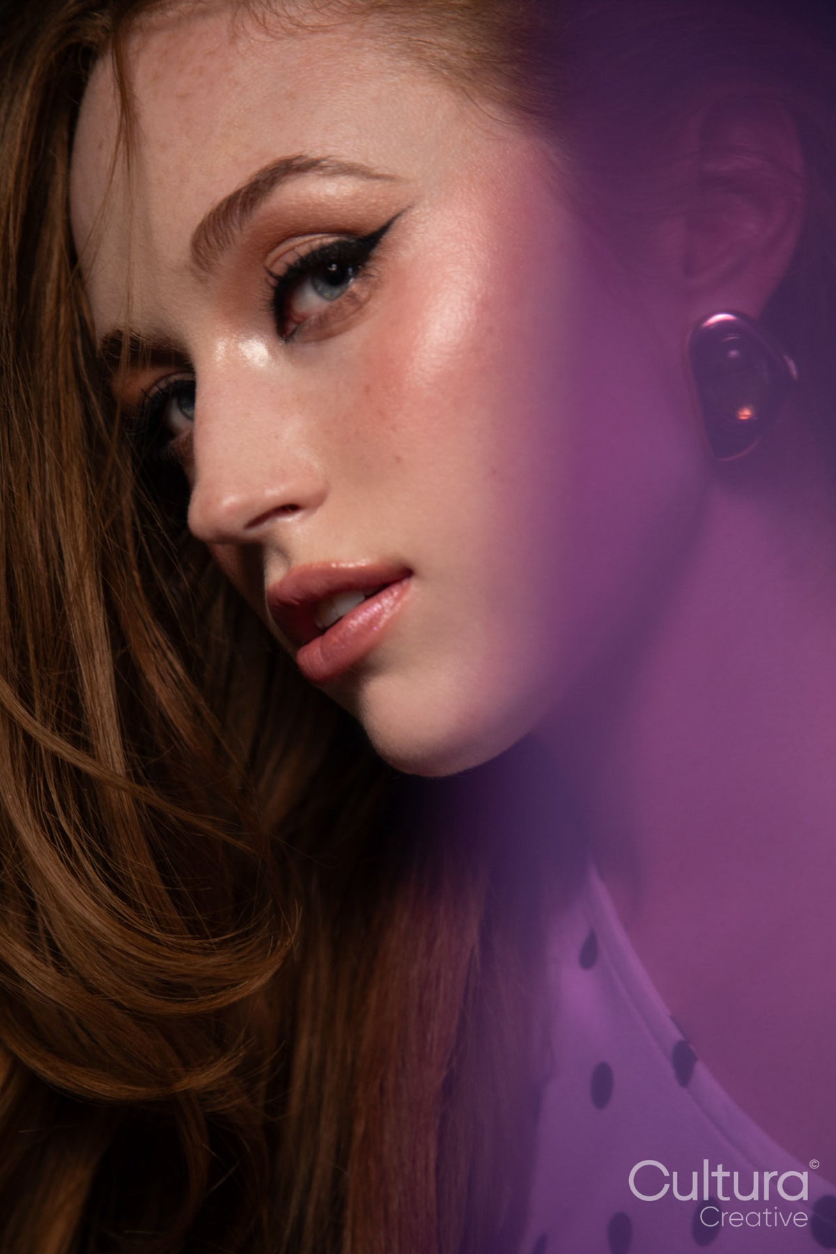 Beauty portrait of a woman with ginger hair and glamorous make-up