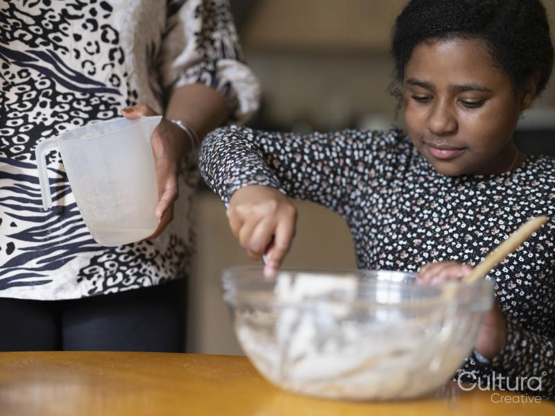 Mother and daughter baking at home