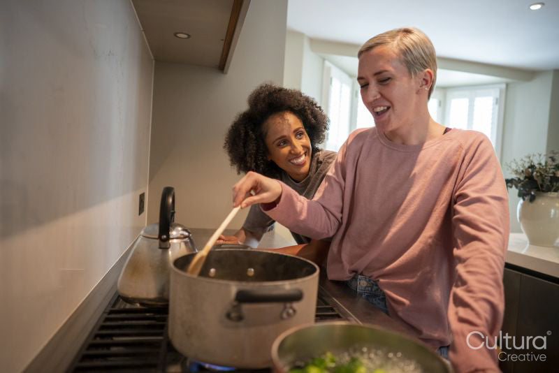 Smiling couple cooking together at home