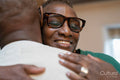 Smiling senior couple hugging at home