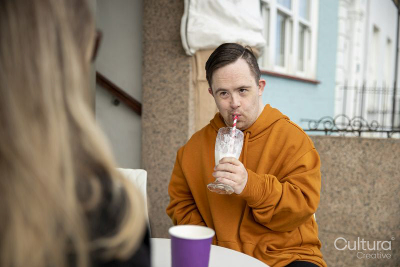 Man and woman sitting at table in sidewalk cafe