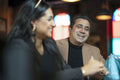 Smiling man and woman sitting in bar