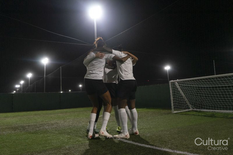 Female soccer players teaming up