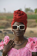 Portrait of young woman wearing headscarf and sunglasses