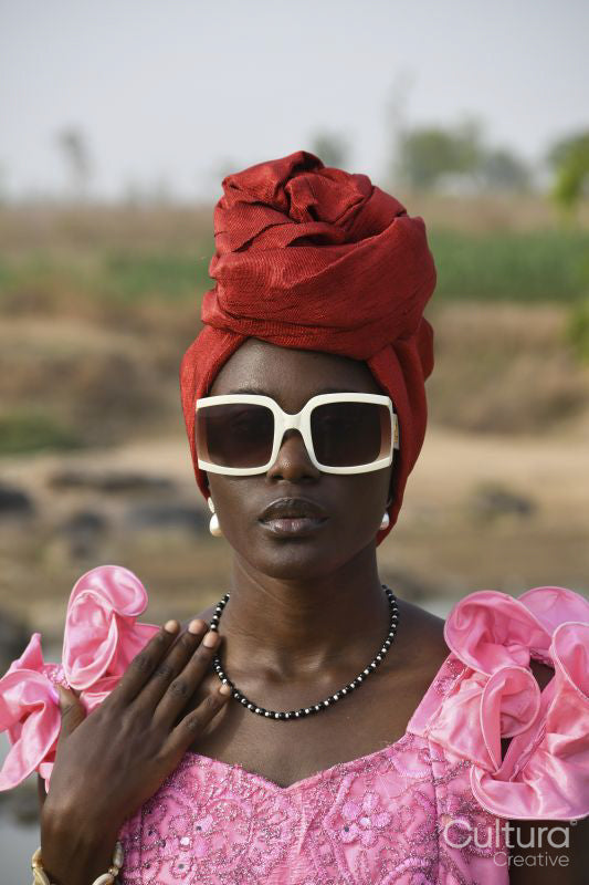 Portrait of young woman wearing headscarf and sunglasses