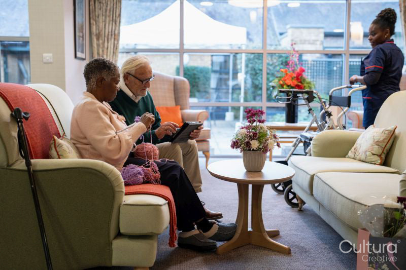 Senior man and woman relaxing on sofa in nursing home