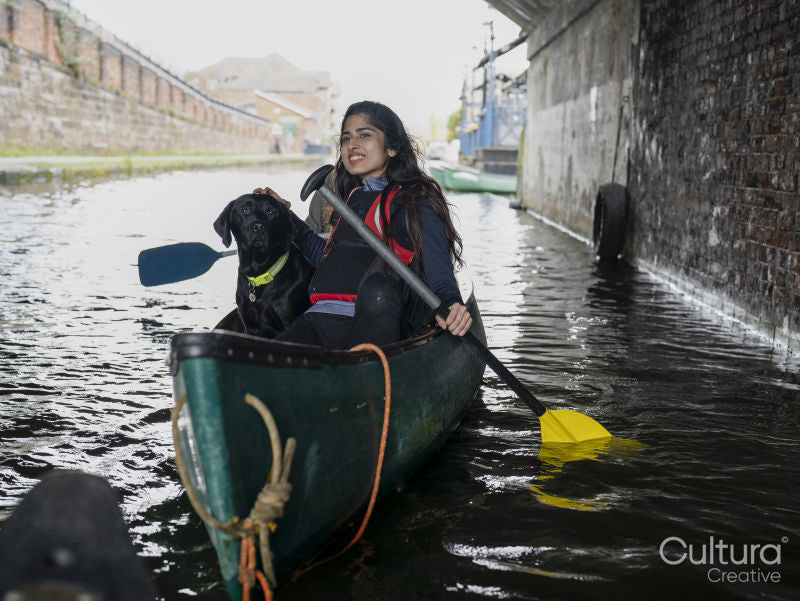 Young woman and dog in canoe