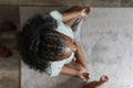 Directly above view young woman practicing yoga at home