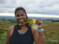 Portrait of smiling female athlete holding medal