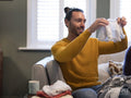 Man looking at baby clothing