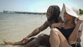 Smiling couple sitting on beach