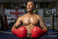 Mature man wearing boxing gloves in boxing ring