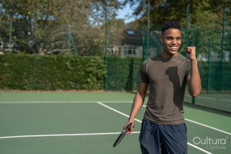 Smiling man in pickleball court