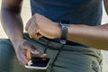 Close up of man using smart phone and smart watch