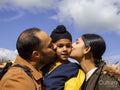 Parents kissing son