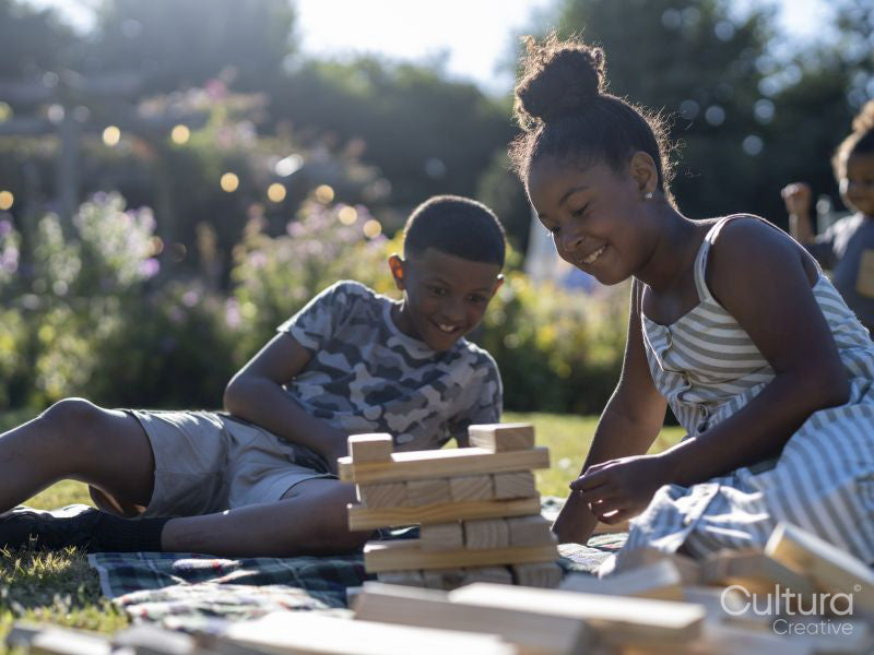 Siblings playing block removal game