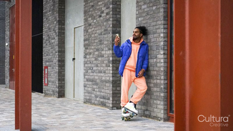 Young man wearing blue puffer jacket and roller skates