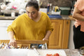 Woman with down syndrome preparing food in kitchen