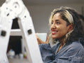 Smiling woman having coffee break during renovation