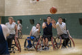 Men in wheelchairs playing basketball