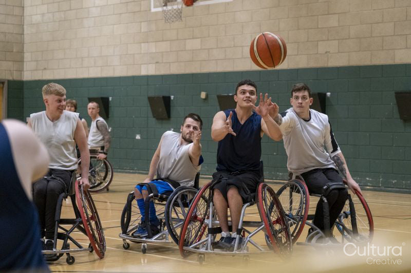 Men in wheelchairs playing basketball