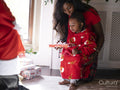 Mother with son taking presents from Santa Claus