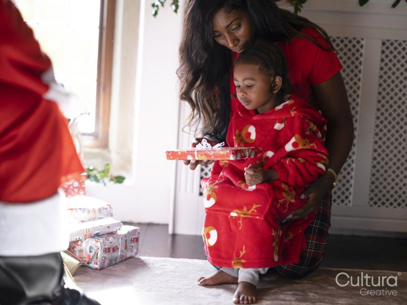 Mother with son taking presents from Santa Claus