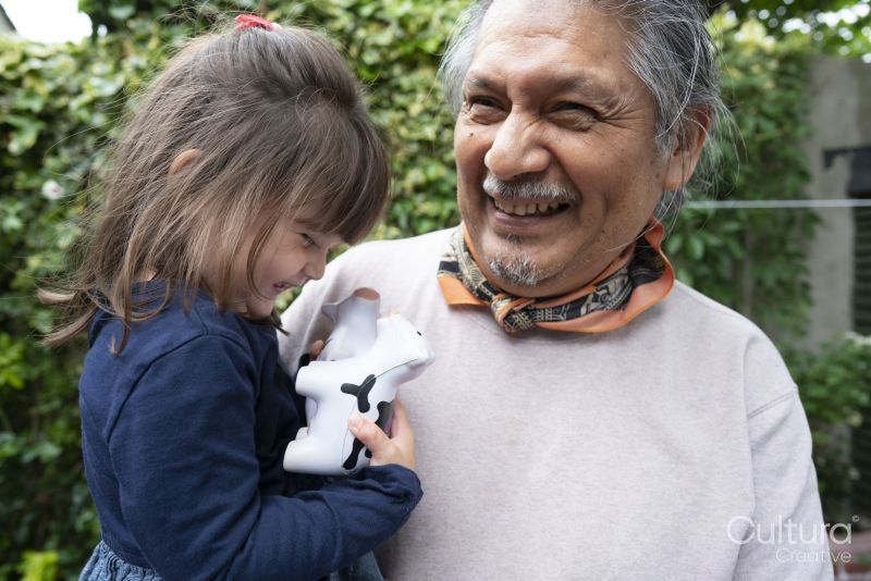 Smiling senior man with granddaughter outdoors