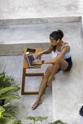 Woman sitting in hotel lounge and using laptop