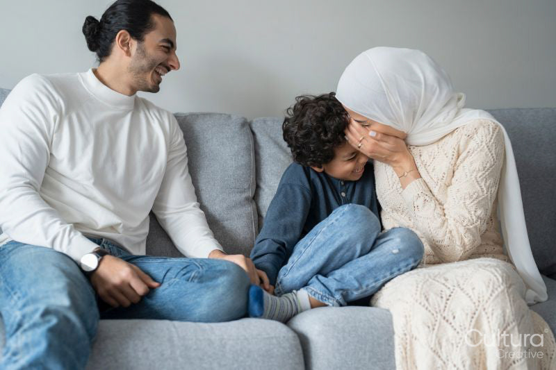 Parents and son relaxing on sofa at home