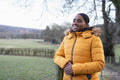 Portrait of woman wearing winter jacket in rural setting
