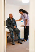 Nurse helping senior man in his room at nursing home